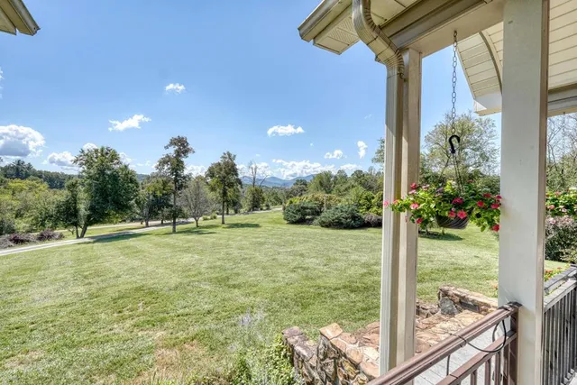 a view of a yard with a building in the background