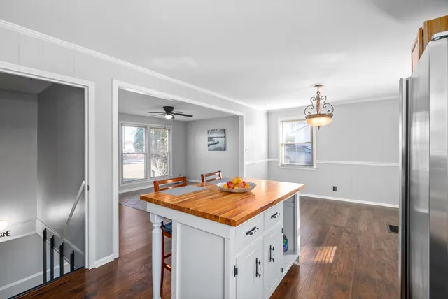 a view of kitchen with stainless steel appliances granite countertop a sink and refrigerator
