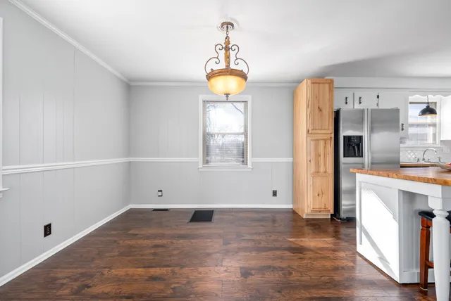 a view of empty room with wooden floor and cabinet