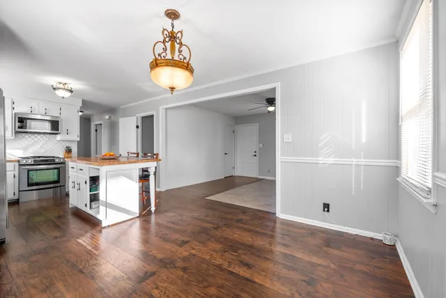 a view of kitchen with cabinets and wooden floor