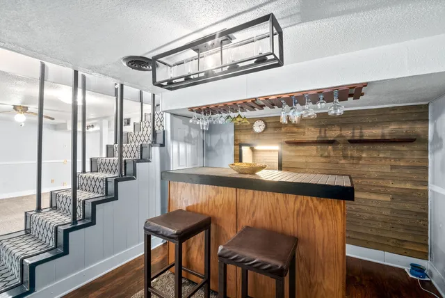 a view of a hallway with furniture and wooden floor
