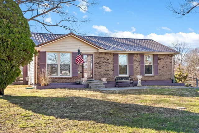 a view of a house with swimming pool and sitting area