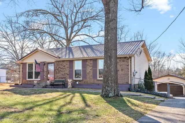a view of a house with swimming pool and sitting area