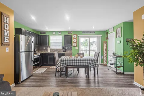 a dining room with furniture and a floor to ceiling window