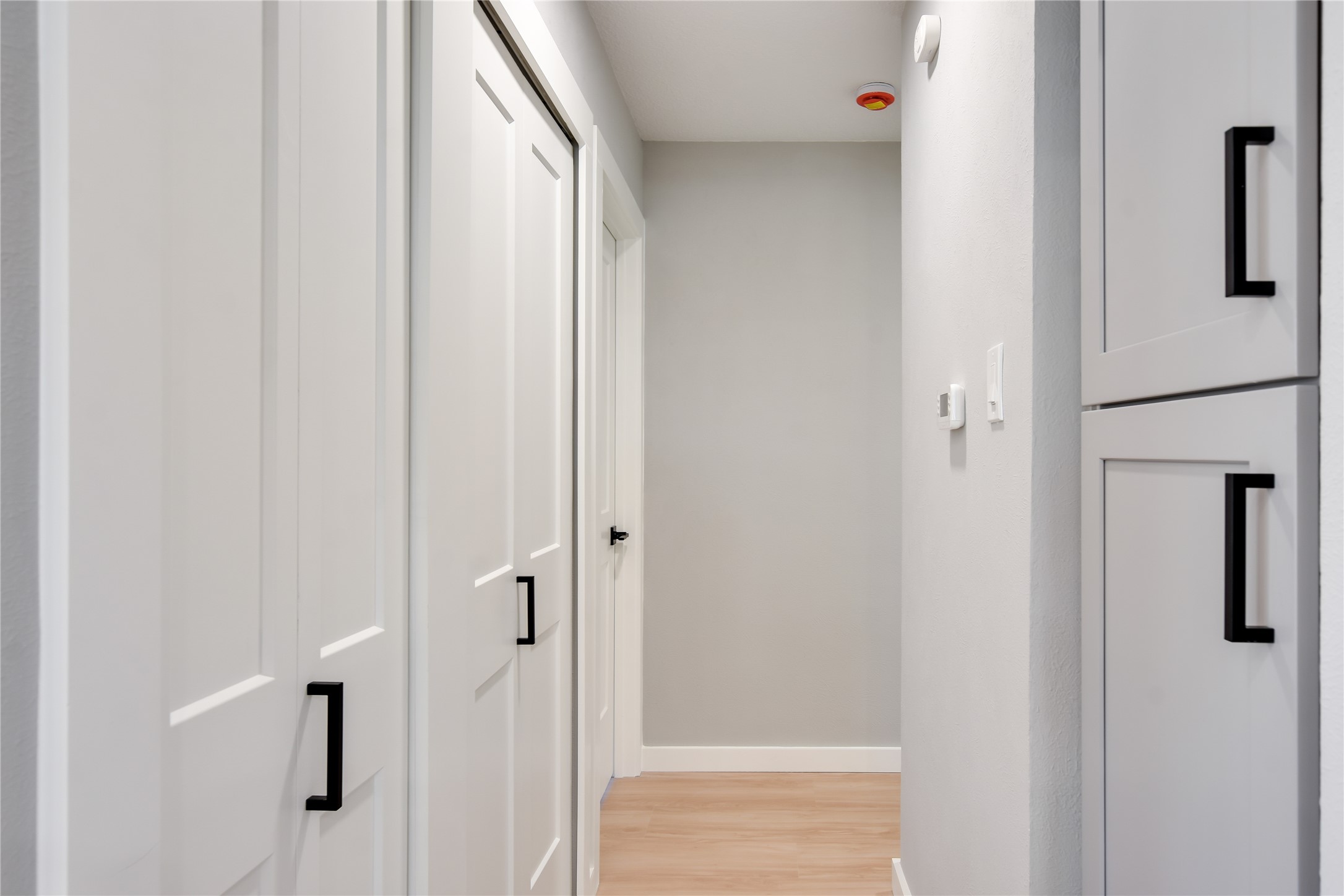 803 Kavanagh Drive Austin, TX 78748 - Photo 12 of 26 Corridor featuring baseboards and light wood finished floors