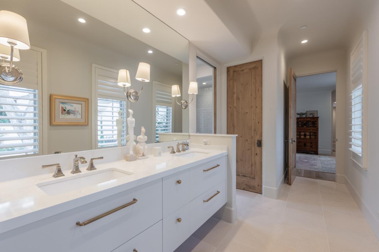 1041 Rodeo Road Pebble Beach, CA 93953 - Photo 9 of 18 a bathroom with a double vanity sink and a mirror