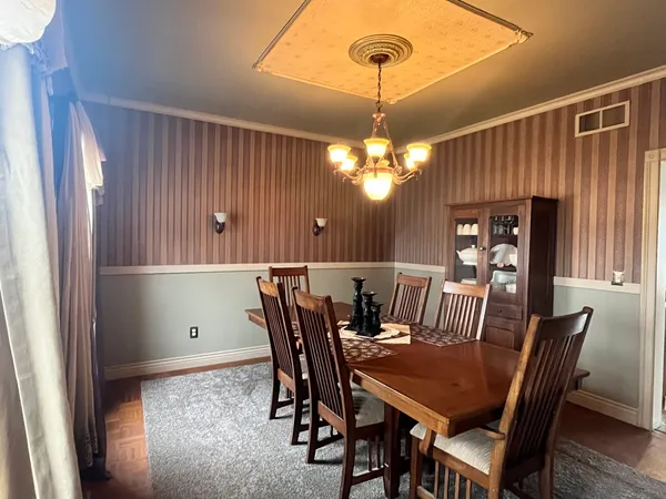 a view of a dining room with furniture and chandelier