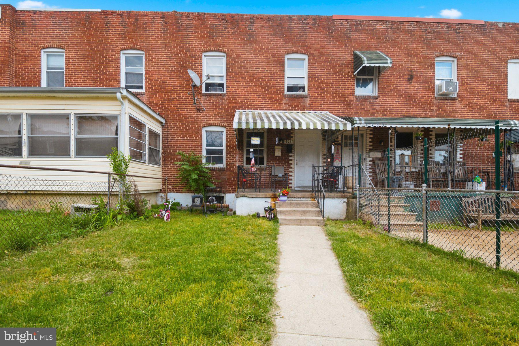 4931 Brookwood Road Baltimore, MD 21225 - Photo 1 of 25 a view of a house with a yard patio and sitting area