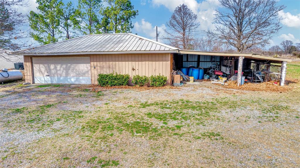 15694 County Road 834 Blue Ridge, TX 75424 - Photo 12 of 14 a front view of a house with a yard and potted plants