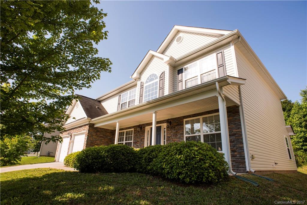 5207 Sunriver Road, Unit 52 Gastonia, NC 28054 - Photo 2 of 24 a front view of a house with a garden