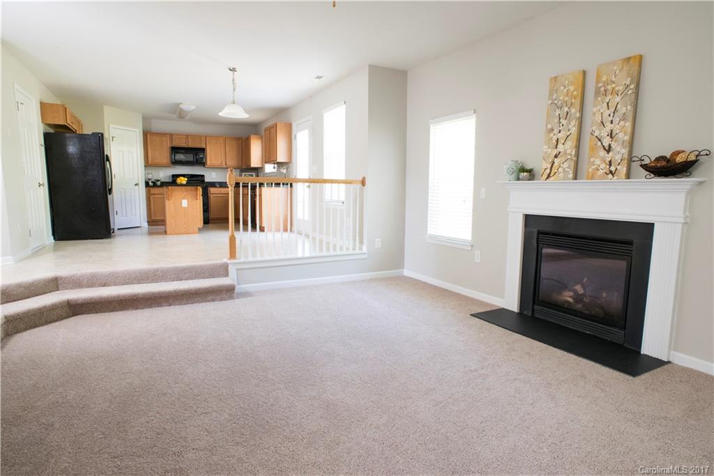 5207 Sunriver Road, Unit 52 Gastonia, NC 28054 - Photo 14 of 24 a view of a kitchen with furniture and a fireplace