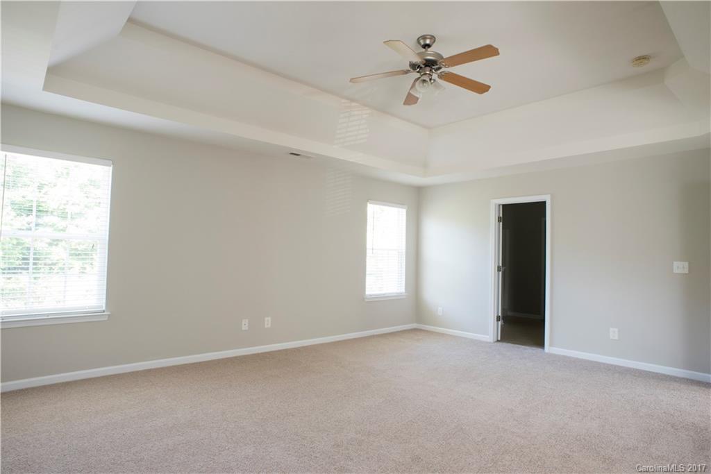 5207 Sunriver Road, Unit 52 Gastonia, NC 28054 - Photo 19 of 24 an empty room with a window and a ceiling fan
