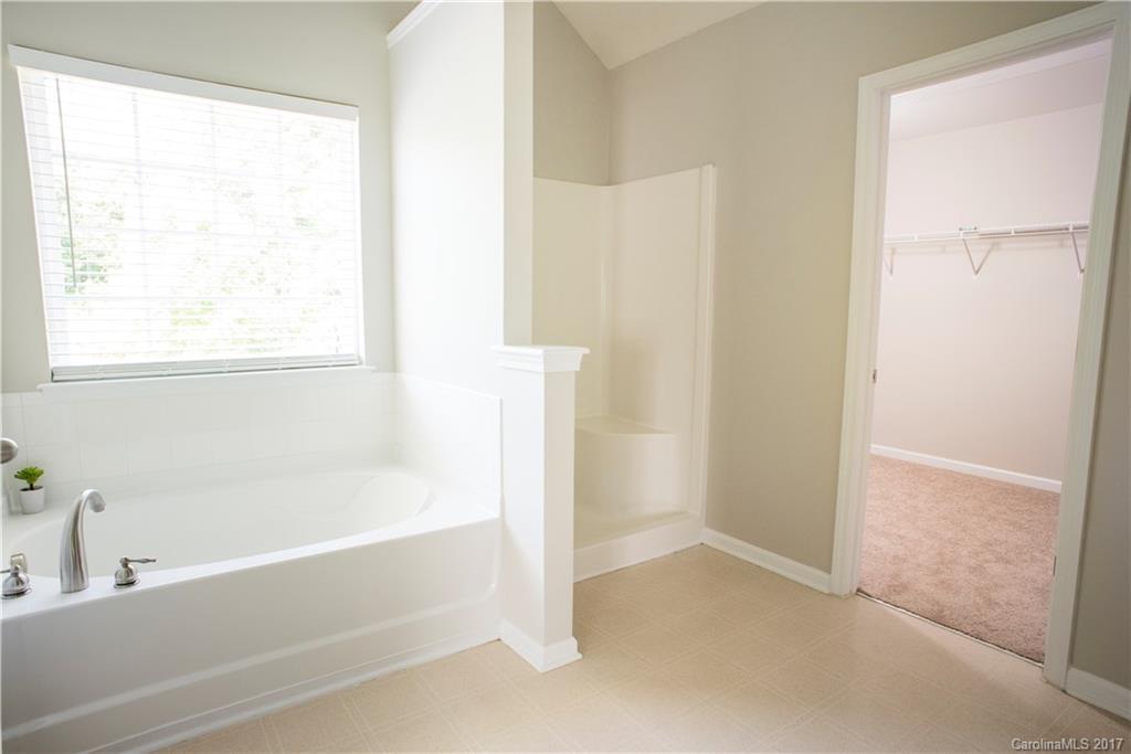 5207 Sunriver Road, Unit 52 Gastonia, NC 28054 - Photo 22 of 24 a bathroom with a bathtub and a shower