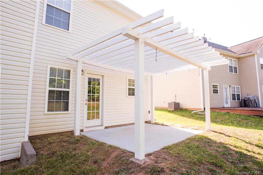 5207 Sunriver Road, Unit 52 Gastonia, NC 28054 - Photo 4 of 24 a view of a house with backyard and sitting area