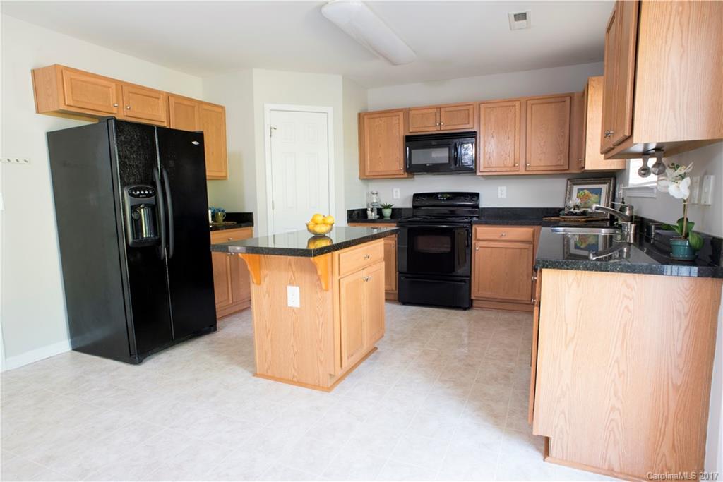 5207 Sunriver Road, Unit 52 Gastonia, NC 28054 - Photo 10 of 24 a kitchen with stainless steel appliances granite countertop a refrigerator a stove a sink and a microwave