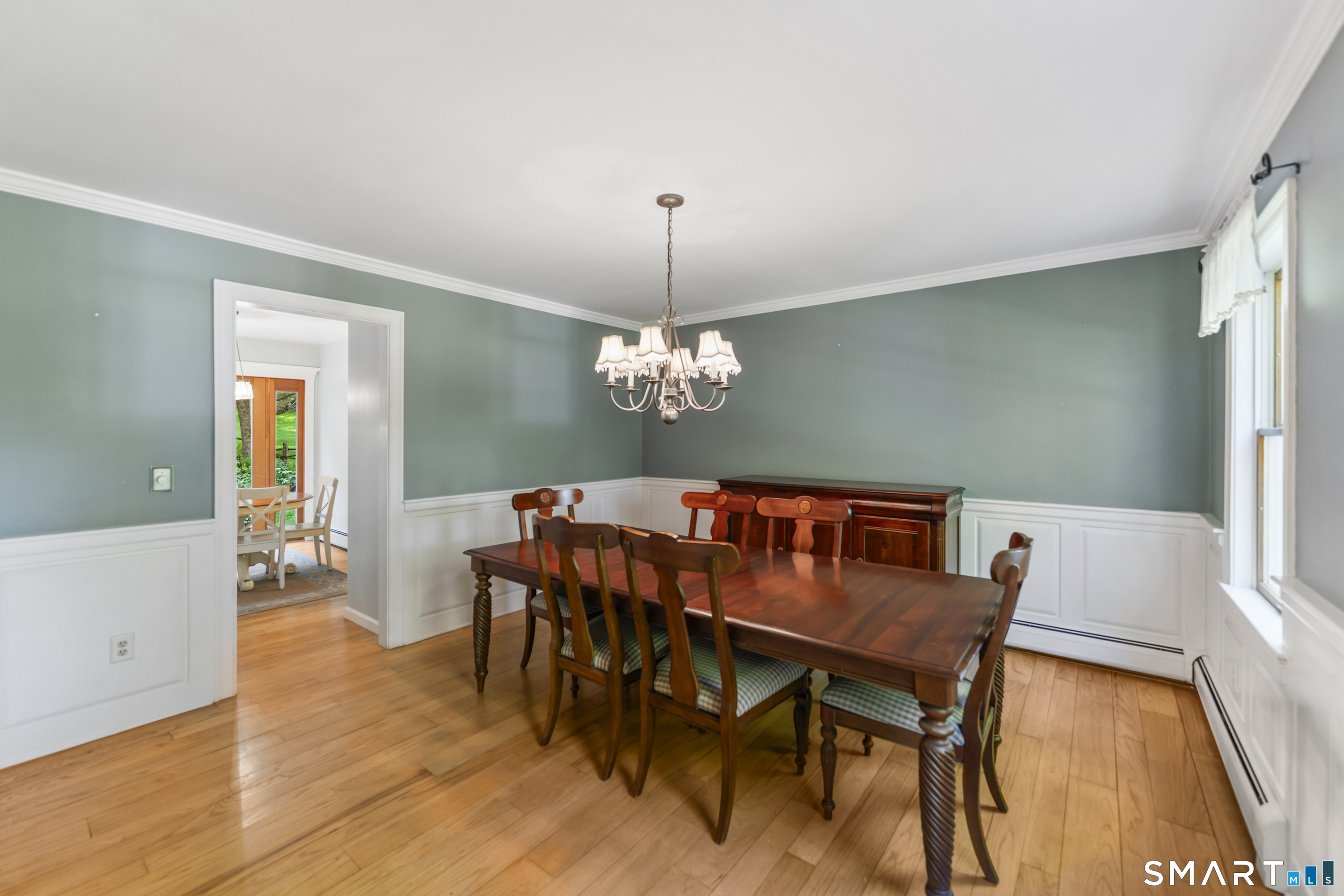 18 Gelding Hill Road Newtown, CT 06482 - Photo 10 of 40 a dining room with furniture a chandelier and wooden floor