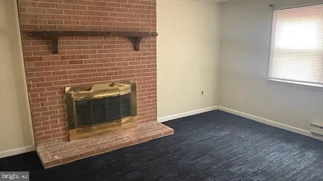 a view of empty room with a fireplace