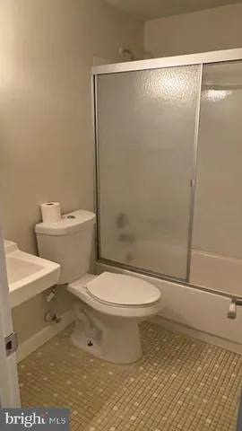 a white toilet sitting next to a bathroom sink
