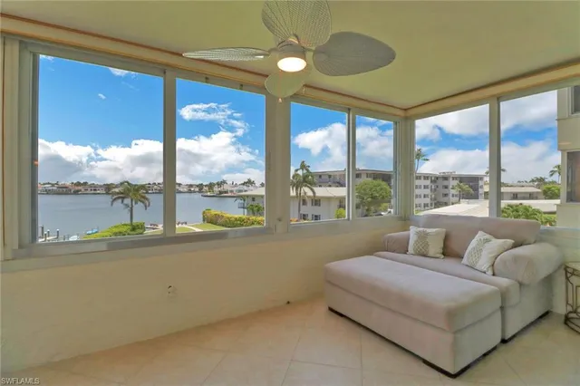 a living room with furniture and large windows