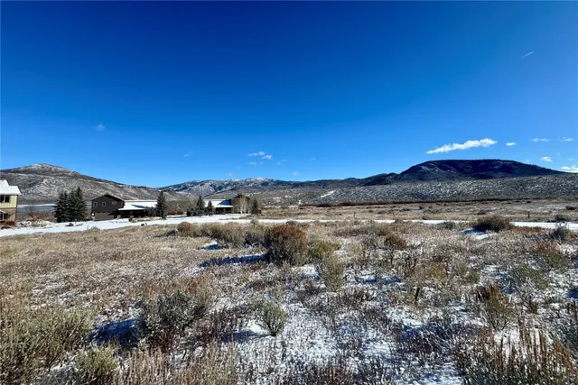 a view of a yard with wooden fence