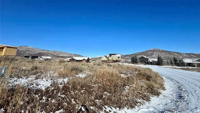 a view of dirt road with a building in the background