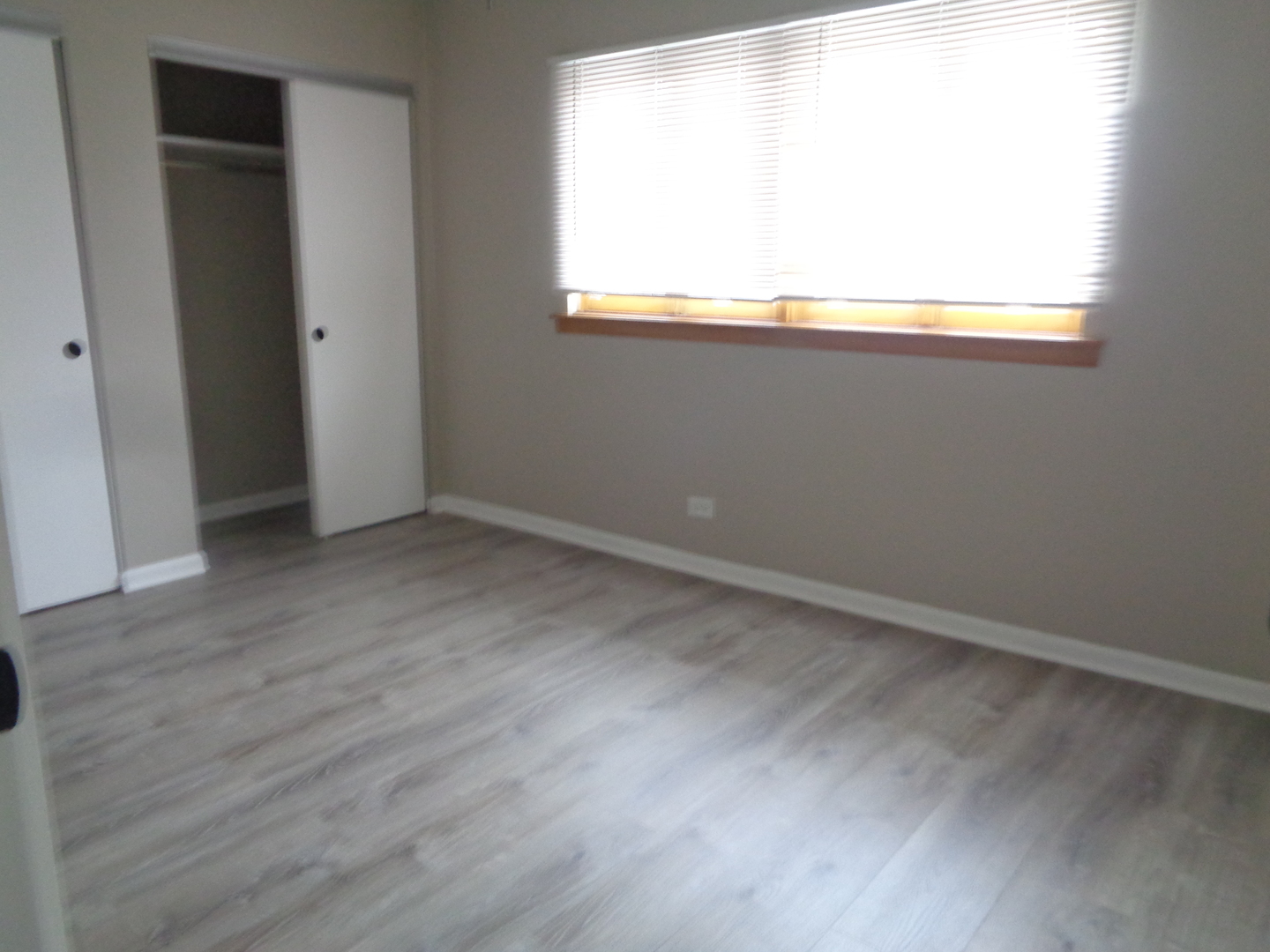 9644 South Kedzie Avenue, Unit 2 Evergreen Park, IL 60805 - Photo 8 of 8 an empty room with wooden floor and windows