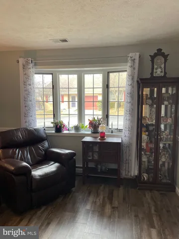 a living room with furniture and large windows