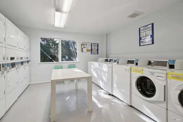 a utility room with cabinets dryer and washer