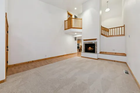 an empty room with fireplace and window