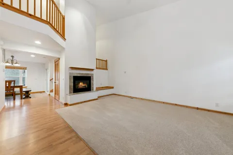 a view of empty room with fireplace and wooden floor
