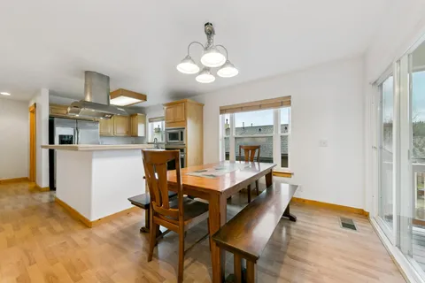 a view of a dining room with furniture and a chandelier