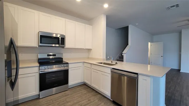 a kitchen with a sink stove and refrigerator