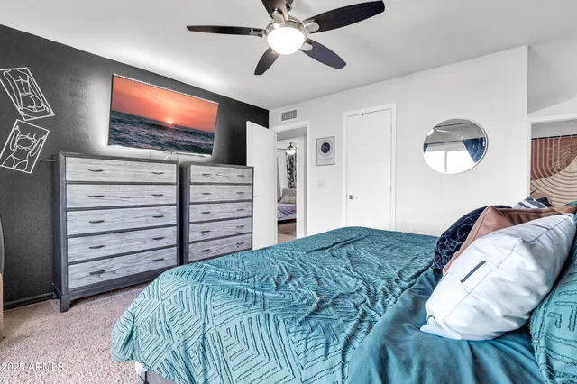 a bedroom with a bed and a flat screen tv