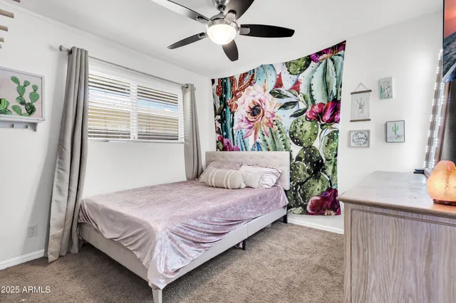 a bedroom with a bed and a large window