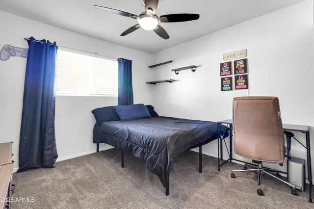 a bedroom with a large bed and a bookshelf