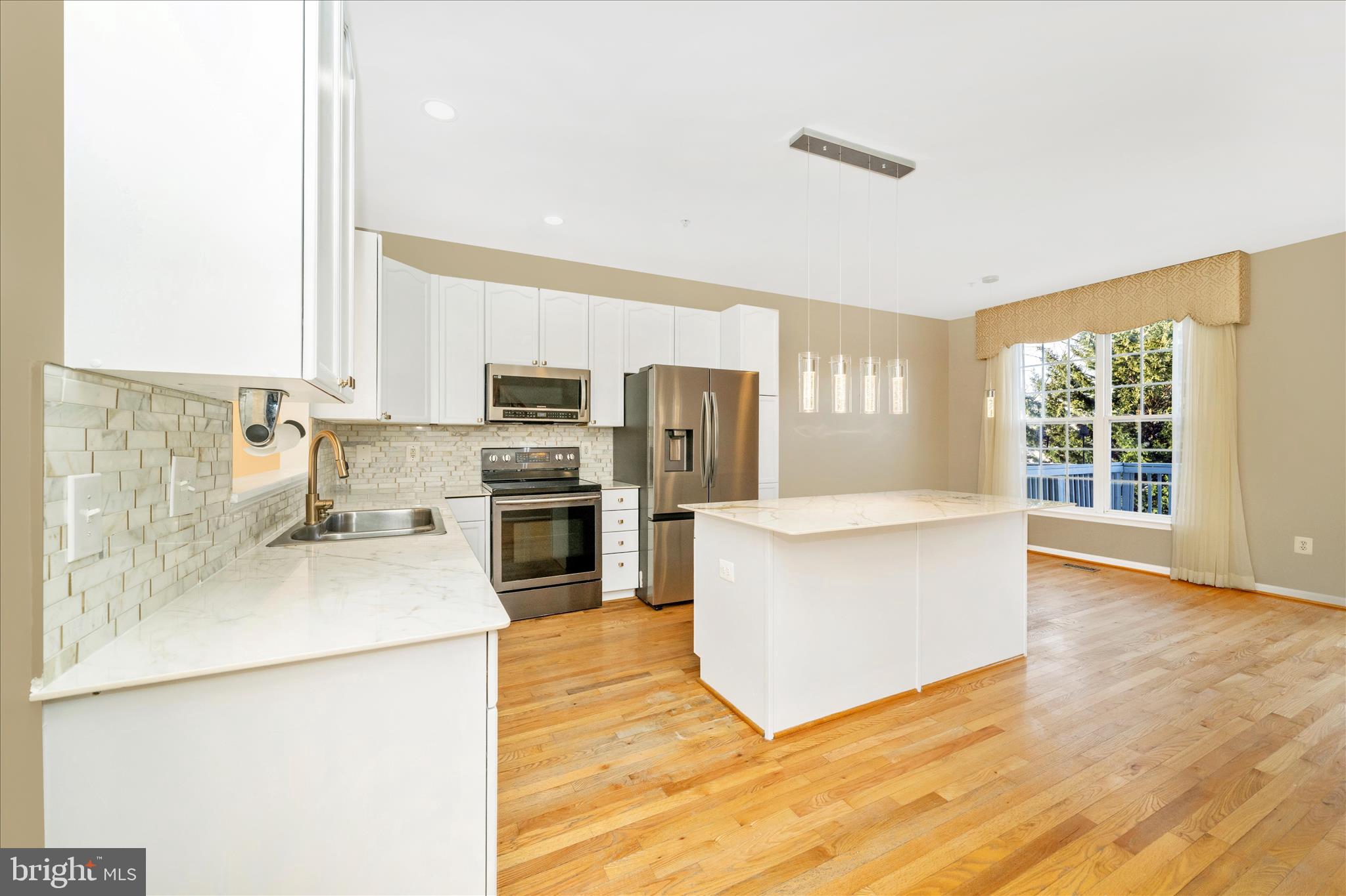 113 Fieldstone Court Frederick, MD 21702 - Photo 15 of 66 a kitchen with stainless steel appliances a refrigerator a stove a sink a center island a stove and a window
