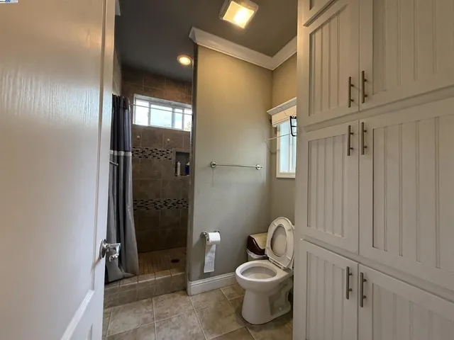 a bathroom with a toilet and shower
