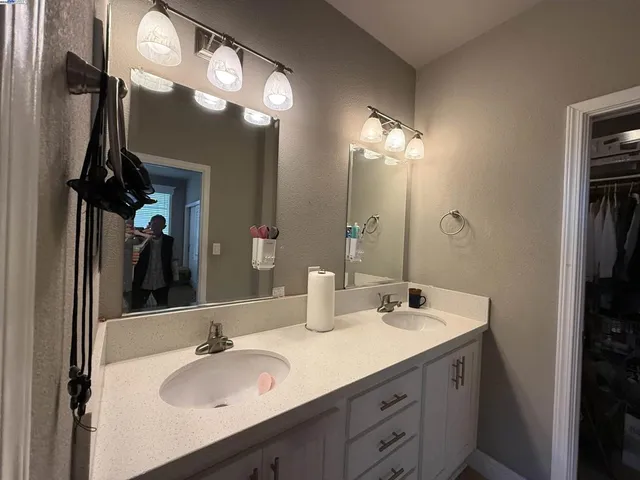 a bathroom with a sink double vanity and a mirror