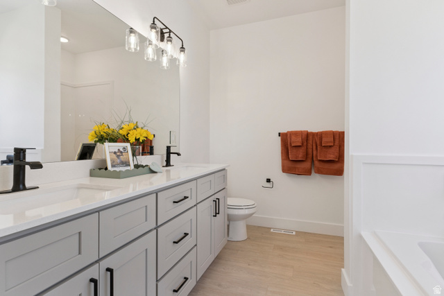 5777 West 4100 South Hooper, UT 84315 - Photo 15 of 41 Bathroom featuring double vanity, light wood finished floors, and a bath