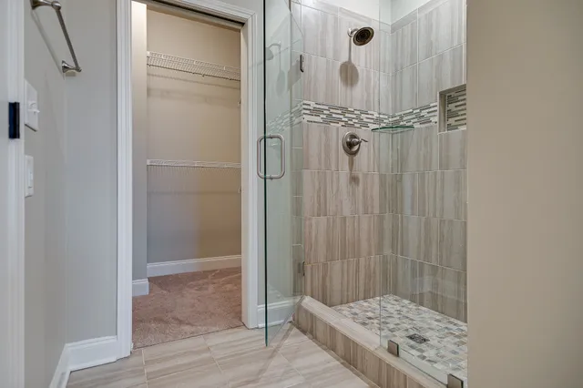a bathroom with a glass shower door