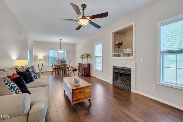 a living room with furniture fireplace and window