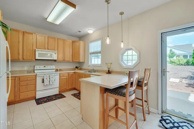 a kitchen with a sink cabinets and wooden floor