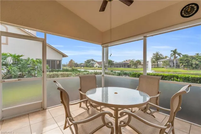 a view of a chairs and table in the patio with a lake view