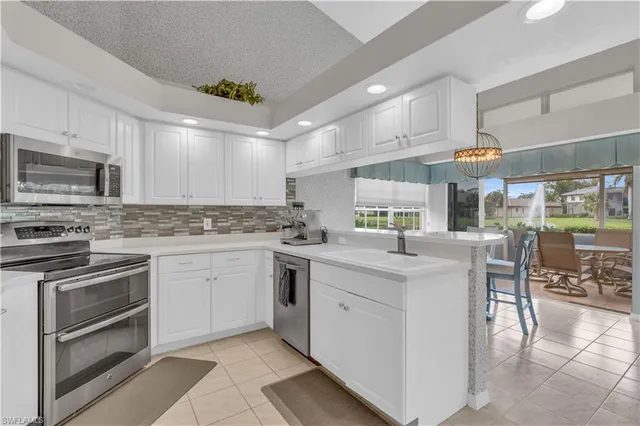 a kitchen with stainless steel appliances granite countertop a sink and cabinets