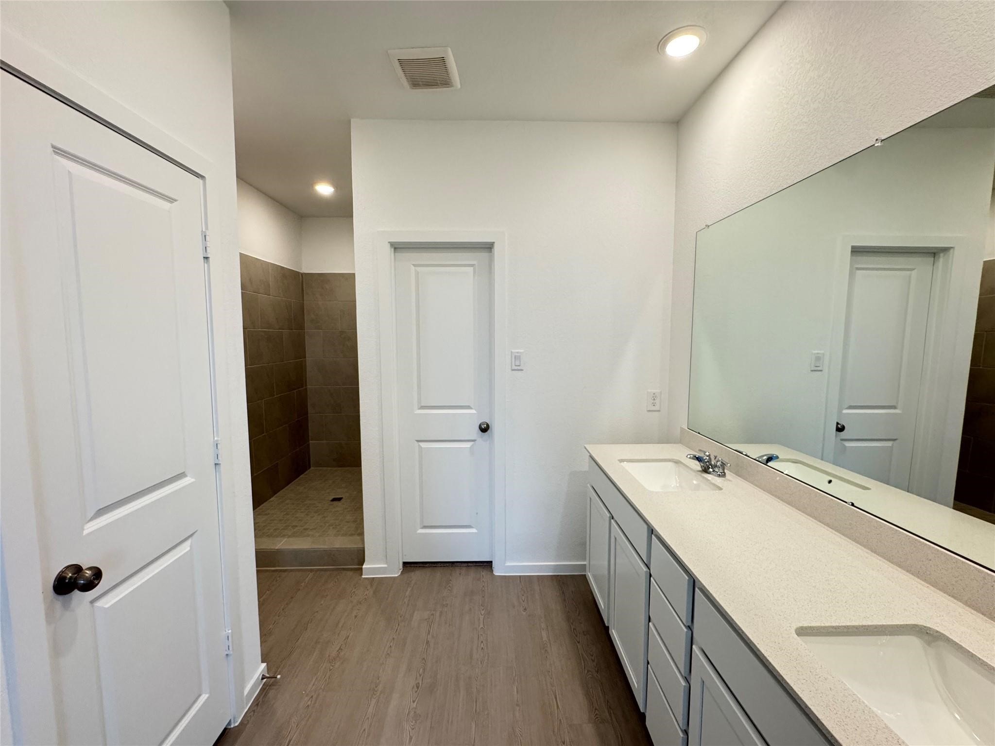 7743 Evening Emerald Drive Rosharon, TX 77583 - Photo 20 of 25 a bathroom with a double vanity sink and mirror