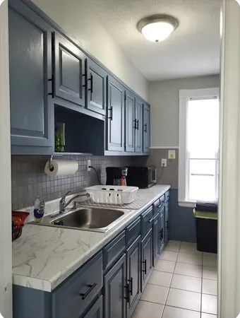 a kitchen that has a sink and a stove in it