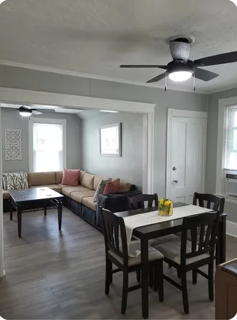 a living room with furniture and wooden floor