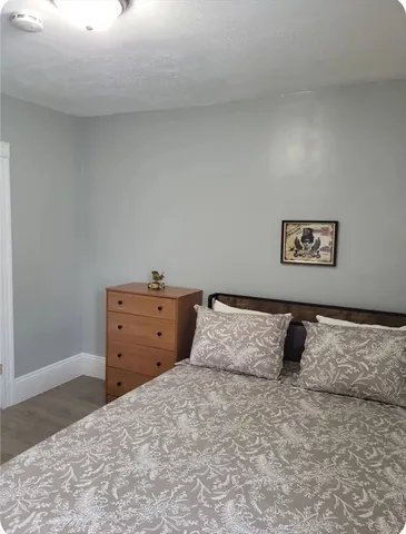 a large bed sitting in a bedroom and dresser
