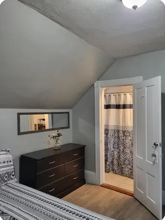 a room with a bed and a dresser
