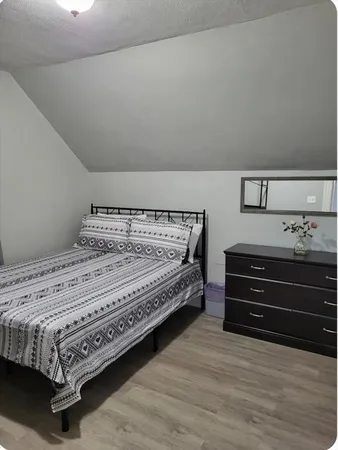 a bedroom with a bed and a dresser